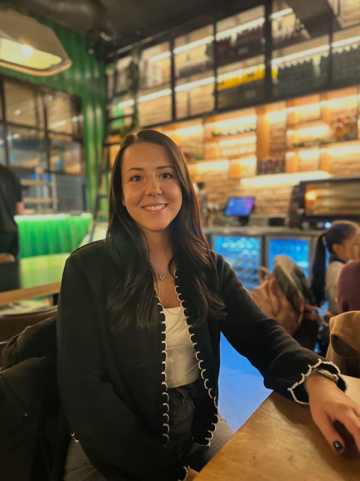 Jasmin Kazittis, Lead Physiotherapist at Carter & George Clinic in Radlett, enjoying time away from work in a restaurant.