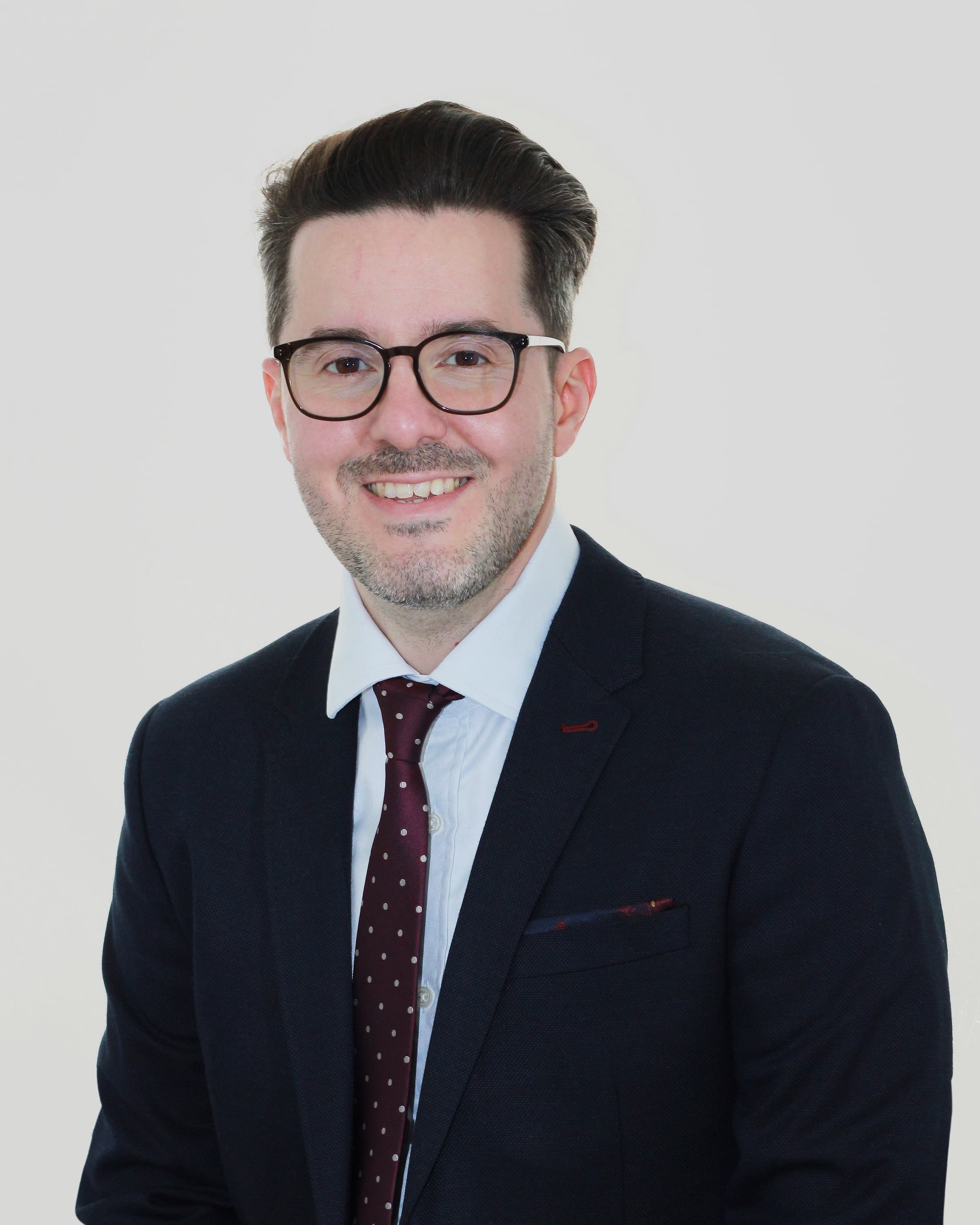 "Dr. Dionisio Izquierdo, Consultant in Sport, Exercise, and Musculoskeletal Medicine, pictured in a professional setting."